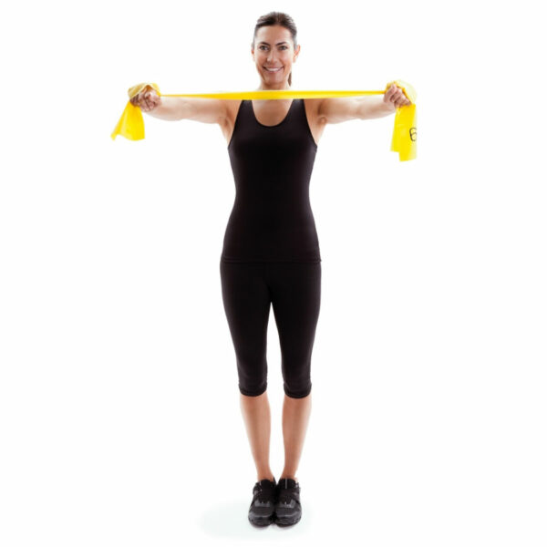 Woman Standing Upright with Yellow Exercise Bands Stretched in Front