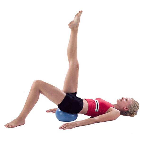 girl using pilates stability ball doing leg exercise on white background