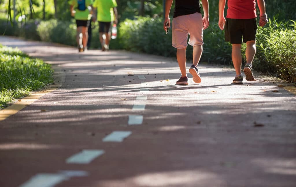 People walking along a path, view of lower half of bodies