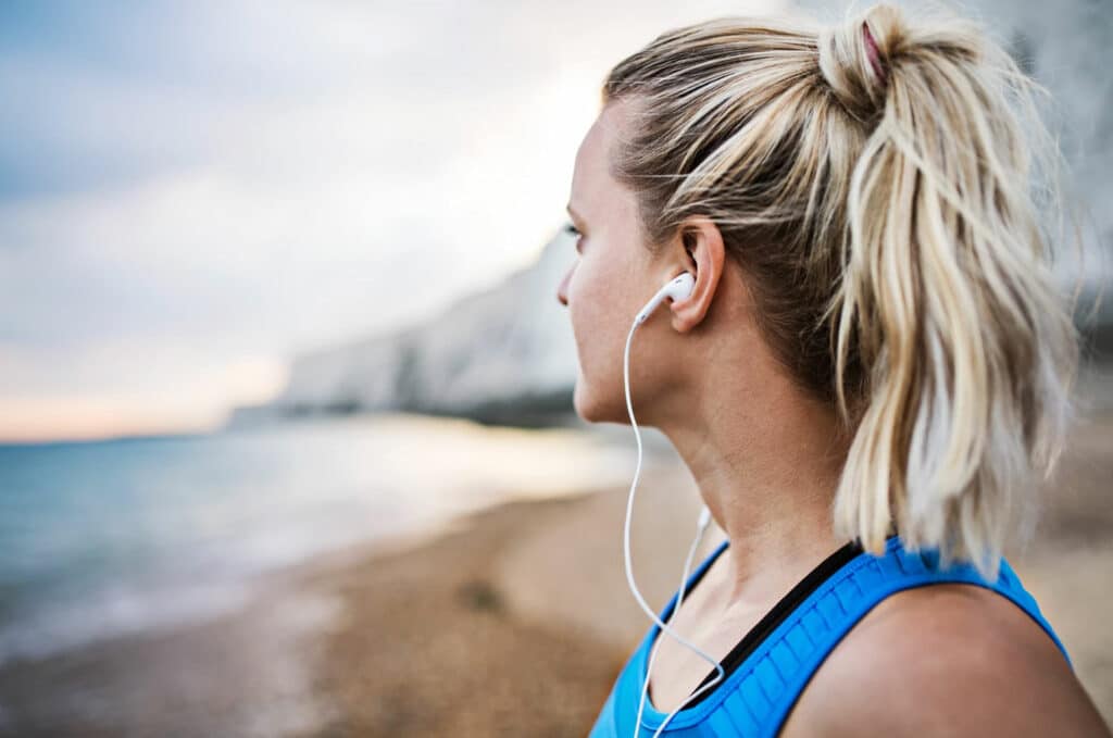 Female runner looking at the beach