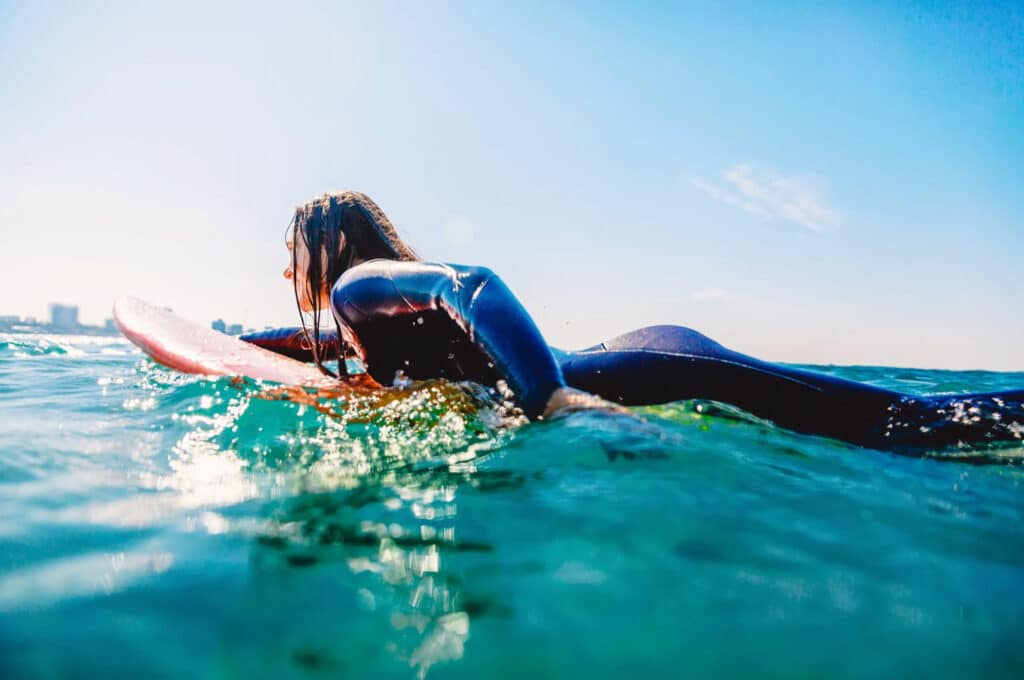 Female surfer exercise in the heat