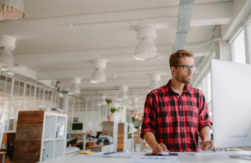 Top 3 Reasons why you have a stiff neck 4 Man standing at work desk