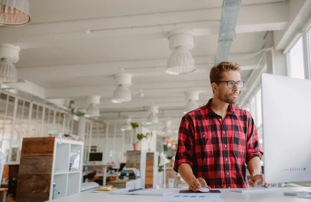 Man standing at work desk