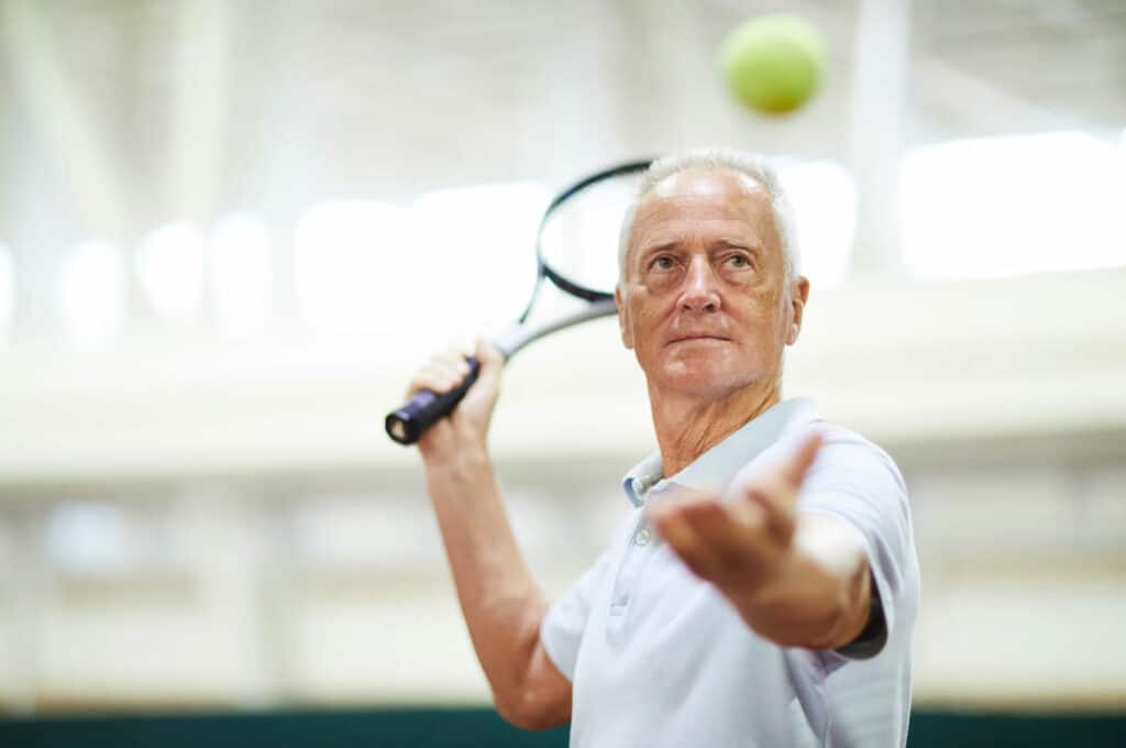 Older man playing tennis