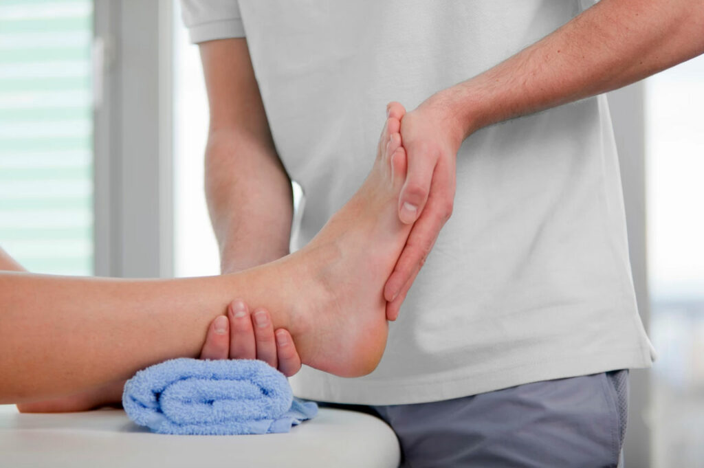 Physio mobilising an ankle sprain