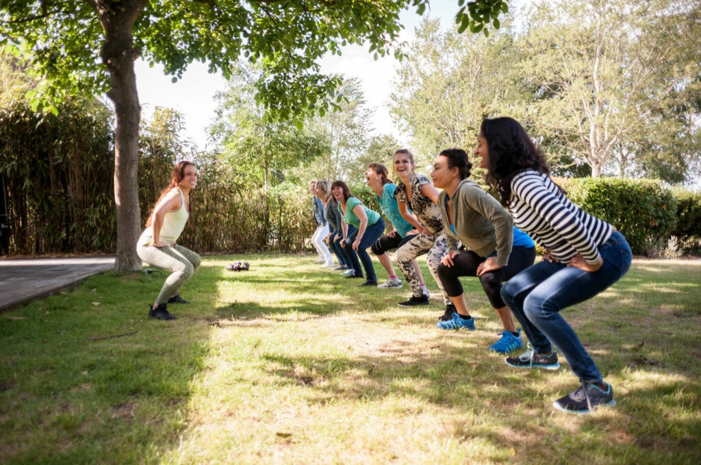 Woman leading exercise class outside