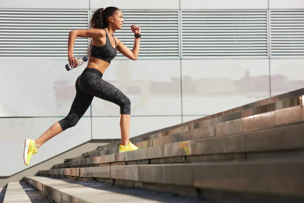 woman-in-yellow-running-shoes-sprinting-up-stairs