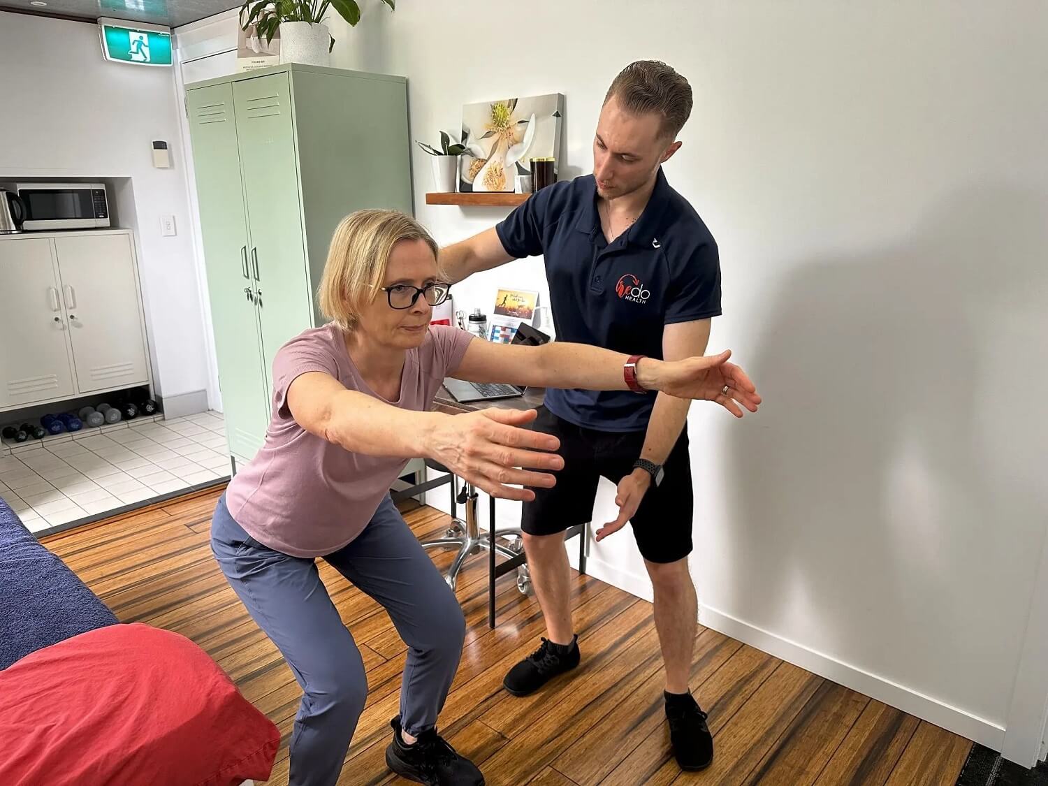 Brendan McGovern guiding a patient through a movement assessment at RedoHealth Balmain